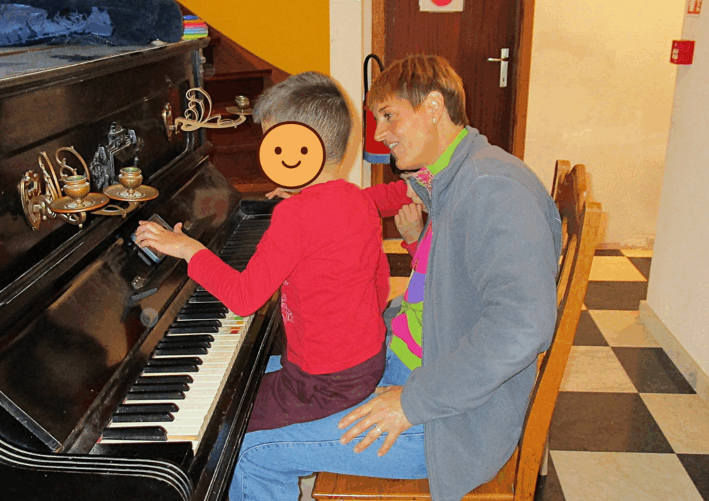 Une enseignante et un jeune garçon qui jouent du piano